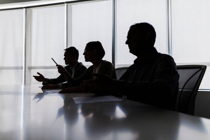 The silhouettes of a board of directors. The silhouettes of a board of directors.