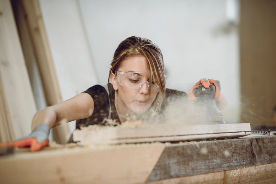 A person working with lumber. A person working with lumber.