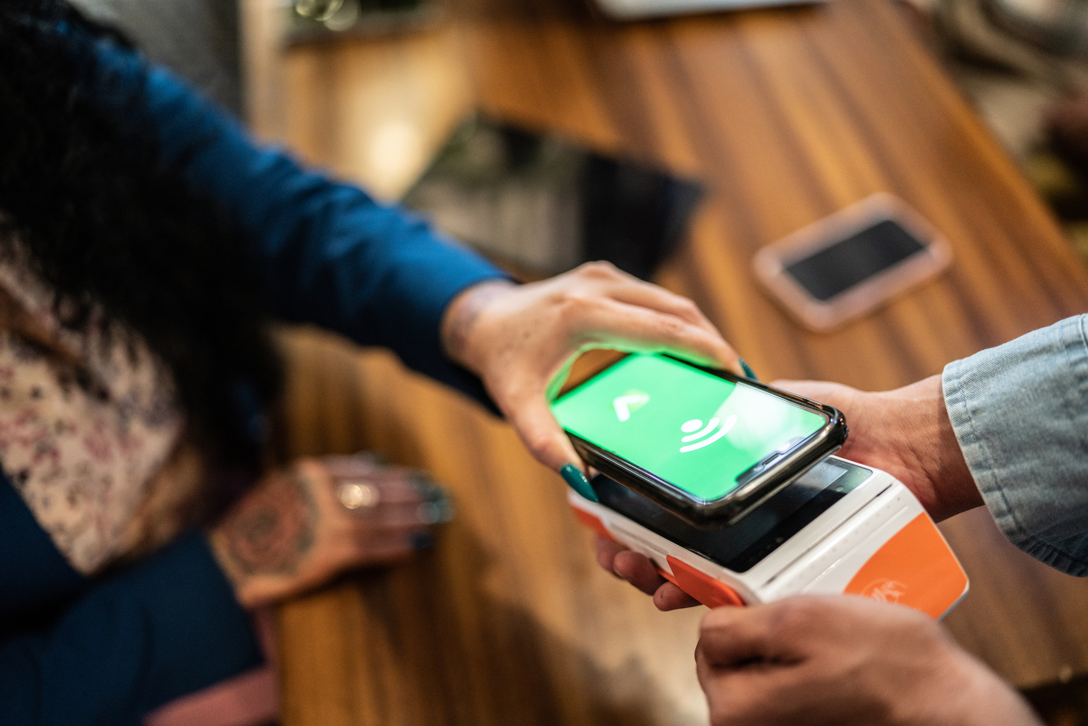 person paying with smartphone in restaurant person paying with smartphone in restaurant