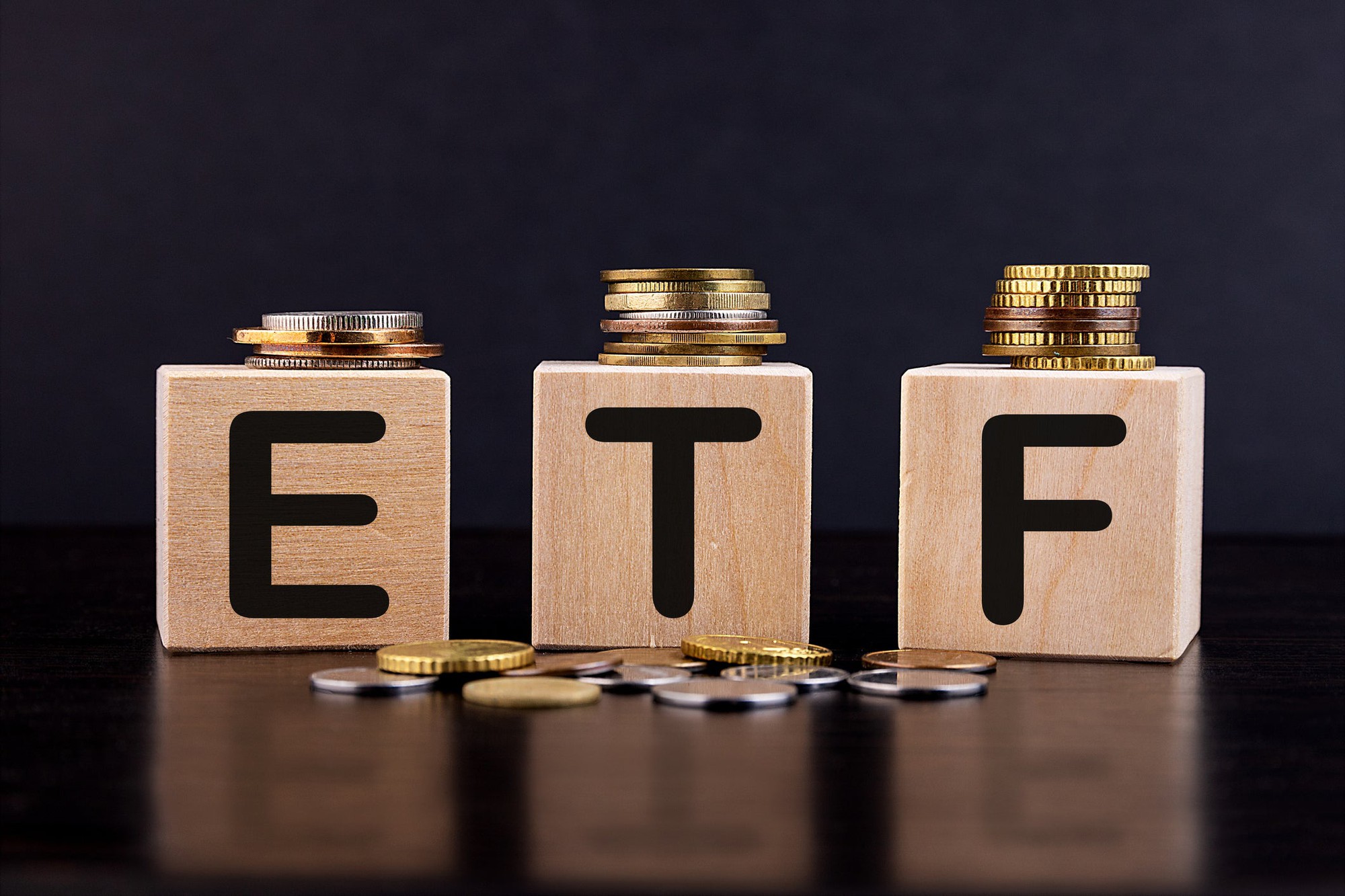 precious_metals_image Coins sit atop of wooden blocks that spell out ETF.