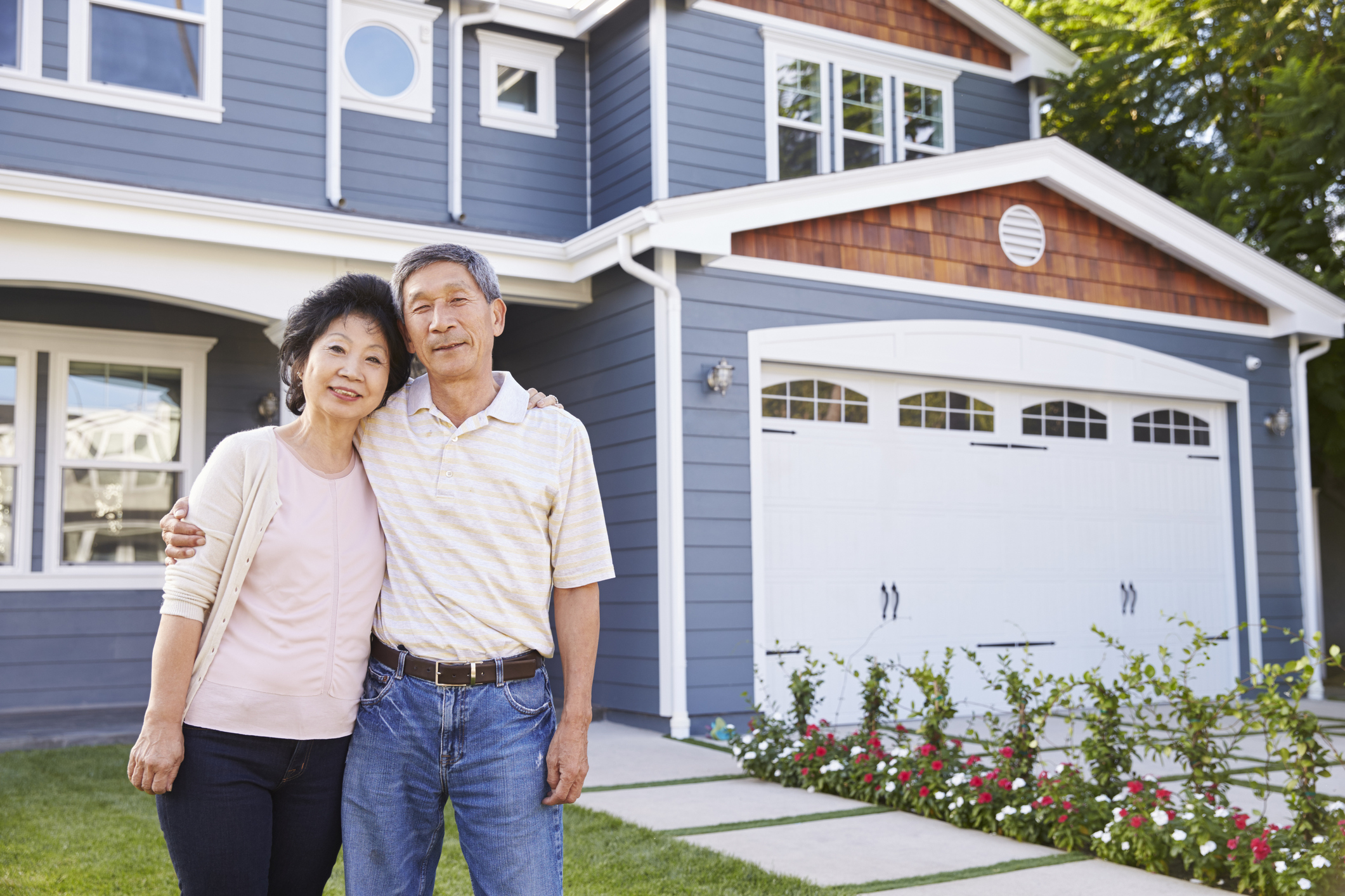two people standing outside house with arms around each other home homeowner
