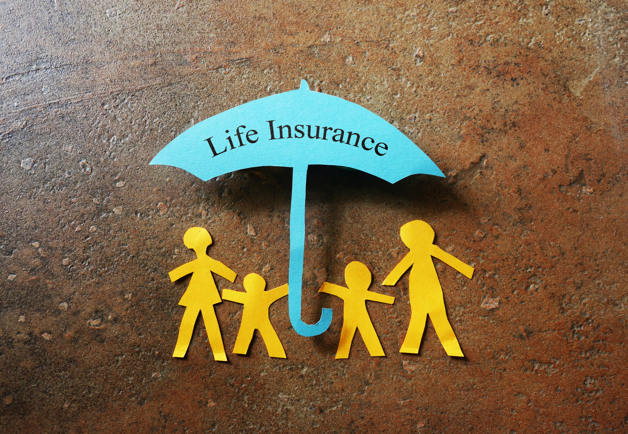 A paper cutout family under an umbrella that reads life insurance. A paper cutout family under an umbrella that reads life insurance.