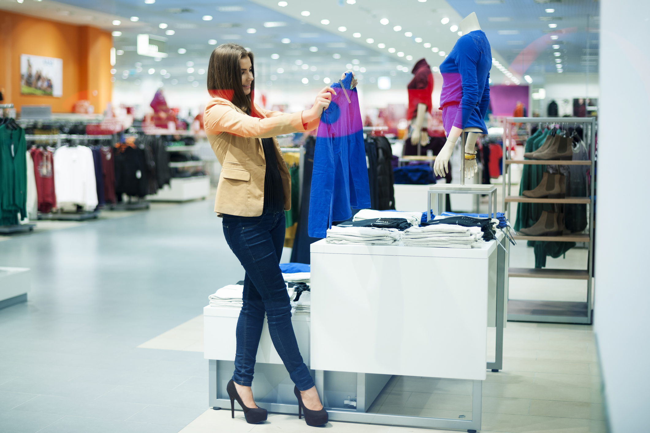 woman clothes shopping A female shopping for clothes off a display.