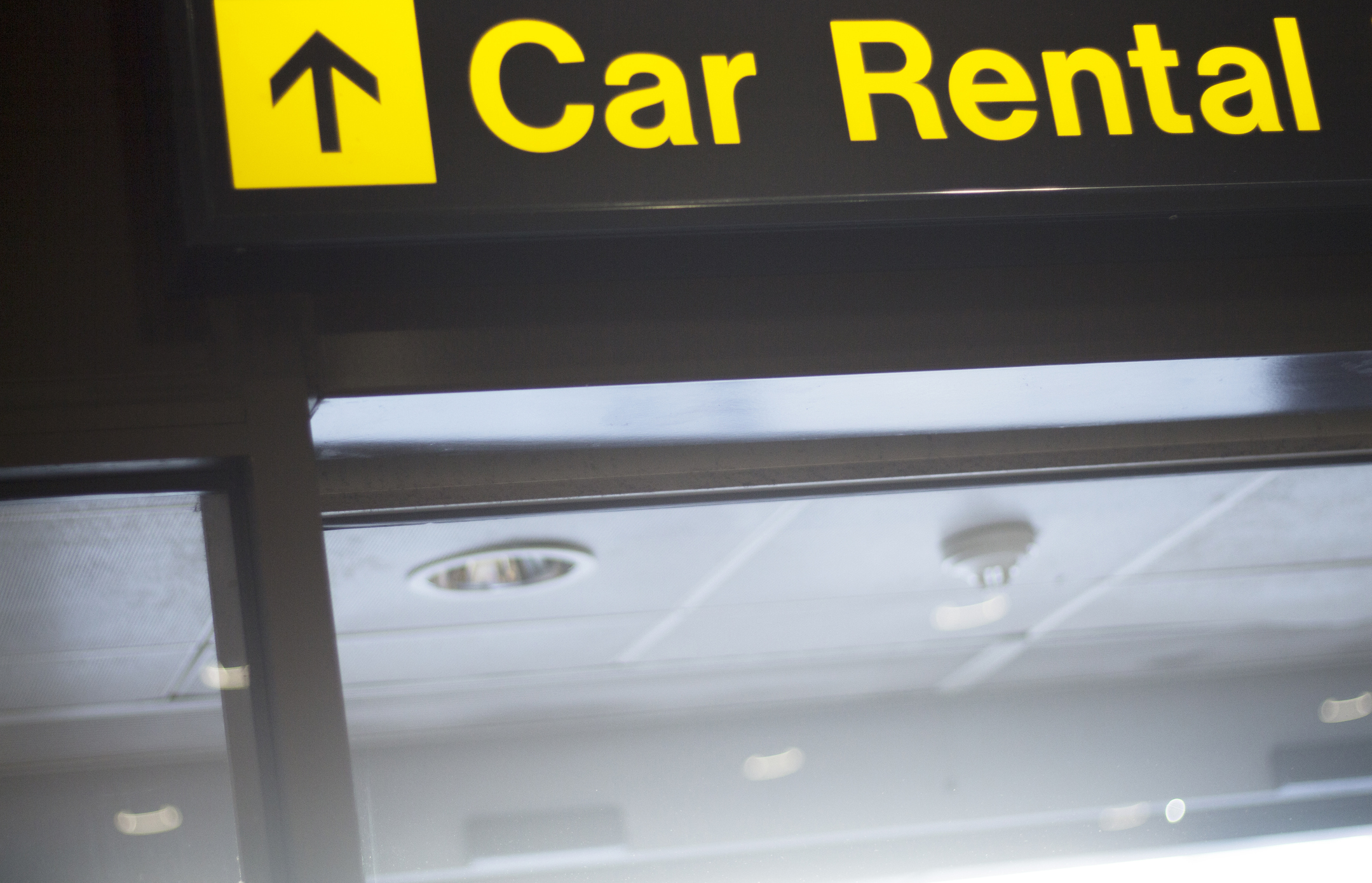 A sign pointing in the direction of Car Rental A sign pointing in the direction of Car Rental.