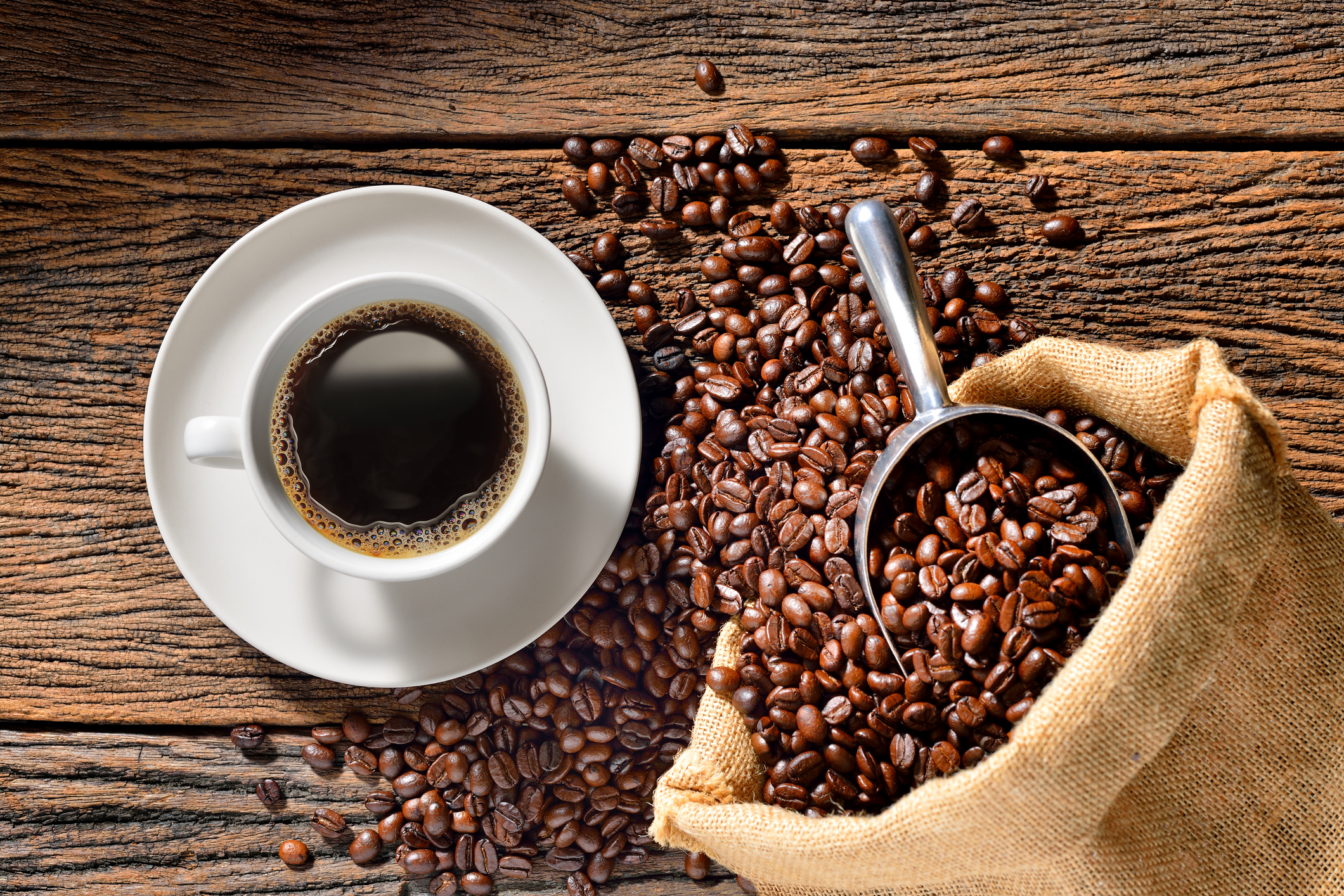 coffee and coffee beans A cup of coffee and a sack of coffee beans.