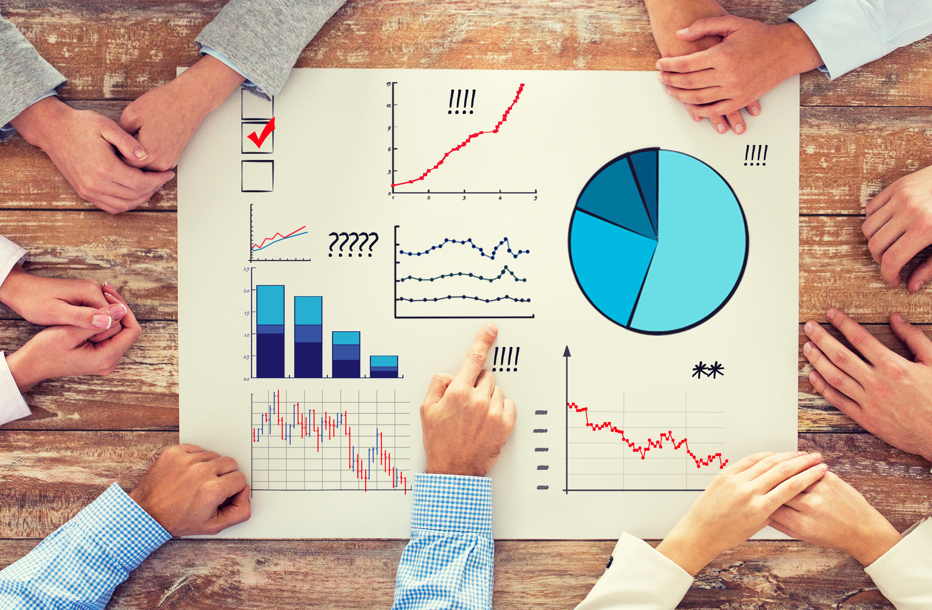 A group of people sketching and analyzing charts and data. A group of people sketching and analyzing charts and data.