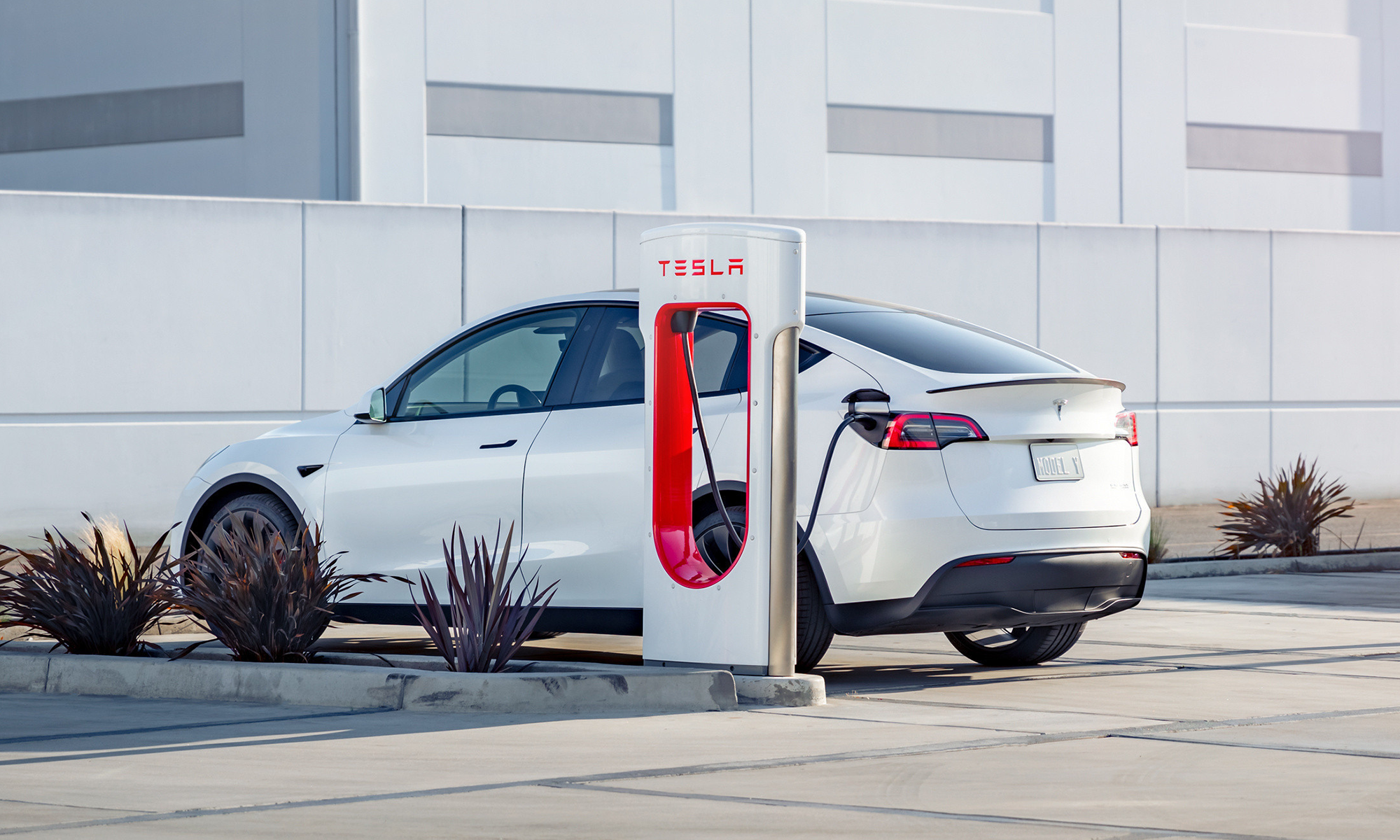 Tesla car at supercharger station. Tesla car at a supercharger station.