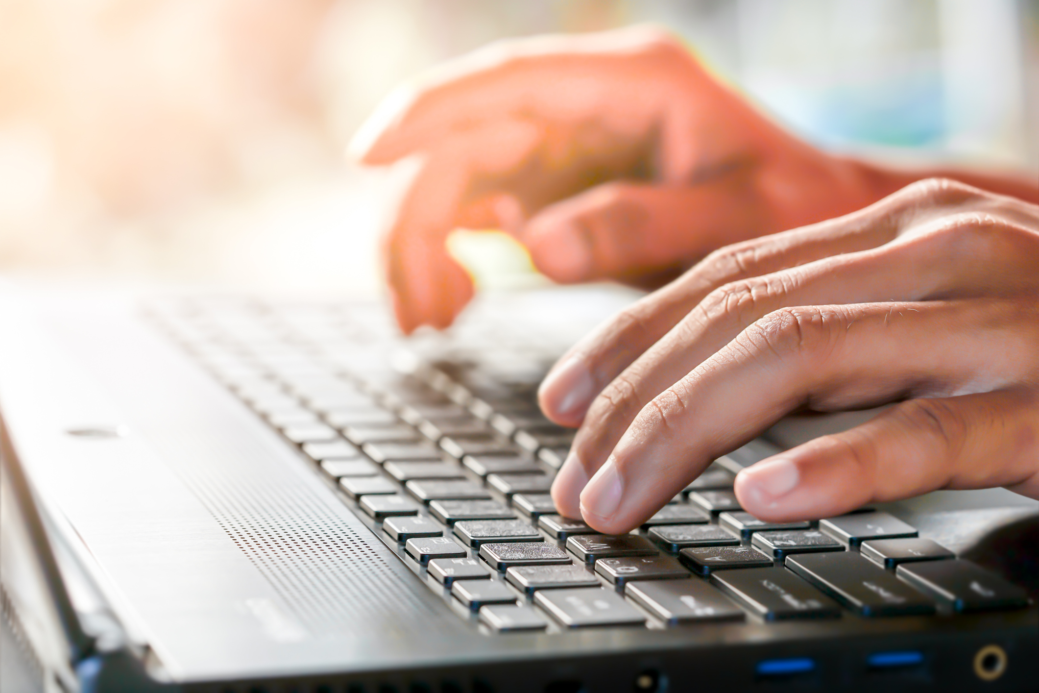 Hands typing on a keyboard. Hands typing on a keyboard.