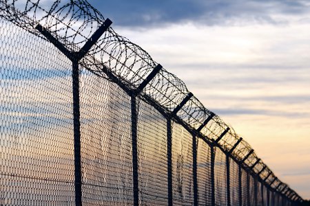 prison wall with barbed wire