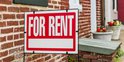 for rent sign in front of brick building