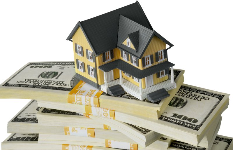 model house on a stack of money