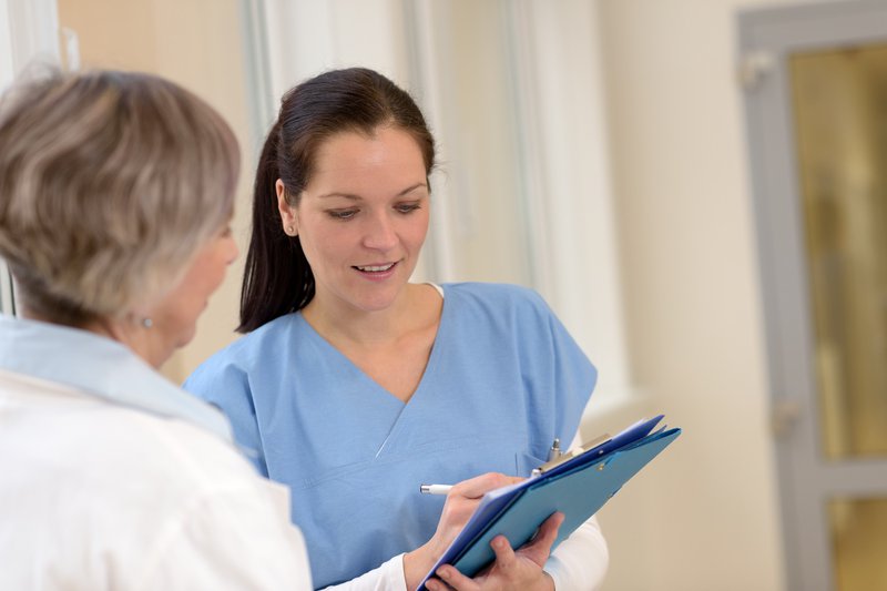 Nurse talking with older woman