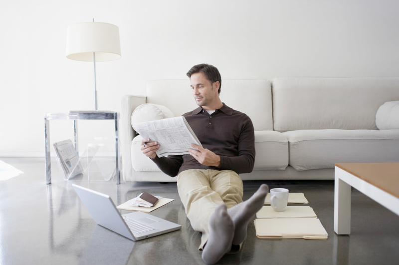 man looking at newspaper