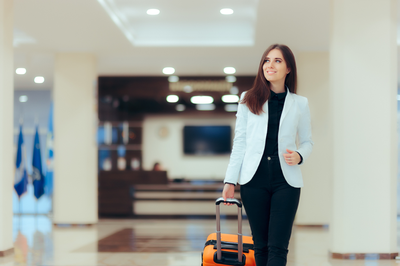 Woman Walking In Mall With Luggage