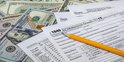 1040 tax form and dollar bills