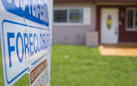 Foreclosure sign in front of house