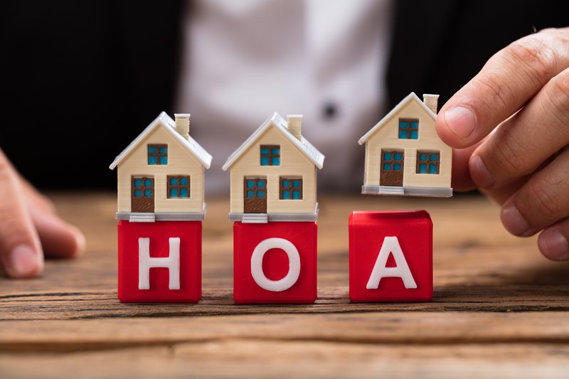 Toy houses sit on blocks spelling out HOA