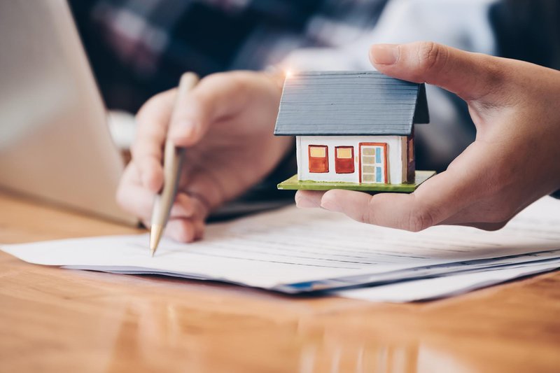 Wooden model of a house with documents