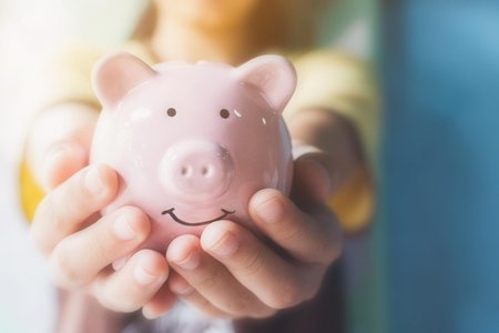 Person holding piggybank