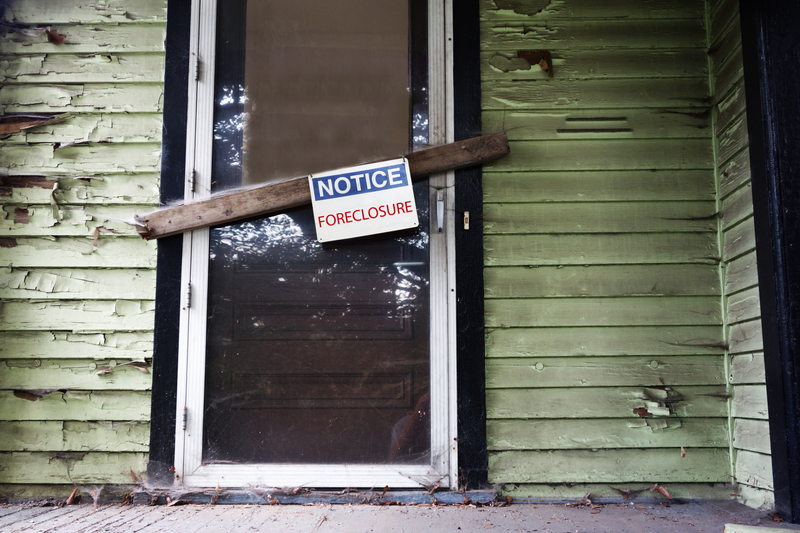 Foreclosure sign in front of house