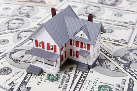 Model house on top of dollar bills