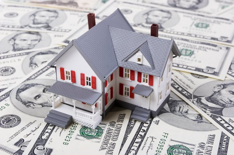 Model house on top of dollar bills