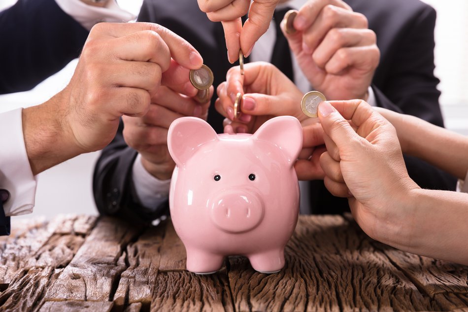 putting money in a piggybank