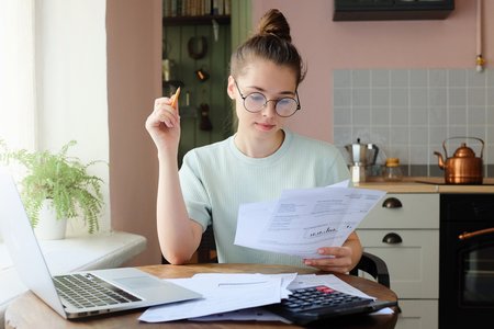 Woman looking at bills