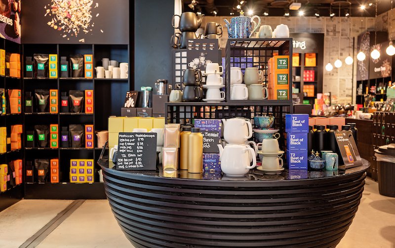 Table display of tea and tea-related products in a store.